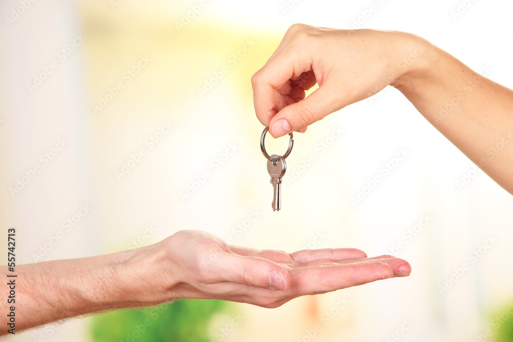 Transfer of house key, on bright background Transfer of house key, on bright background