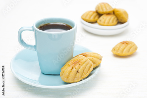 madeleine cookies and a cup of coffee on a white background