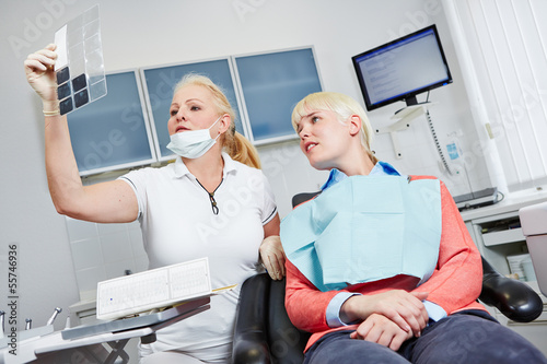 Dentist looking at x-ray image of teeth