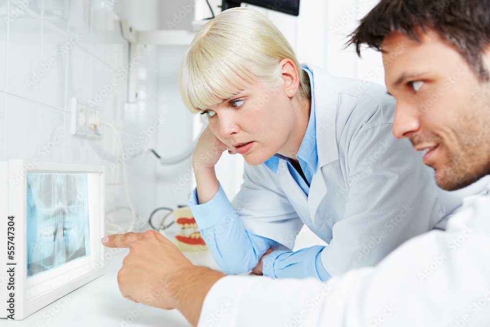 Radiologist and dentist examine panoramic radiograph Radiologist and dentist examine panoramic radiograph