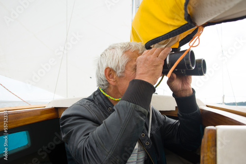 Man with binocular on yacht