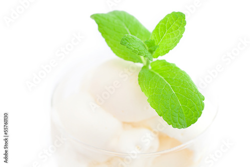 ice cream with mint in a glass bowl isolated on white
