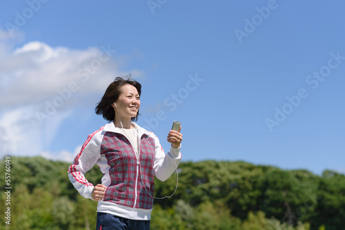 音楽を聴きながらジョギングする女性
