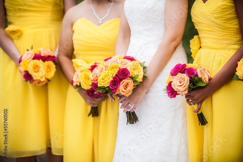 Bride Holding Bouquet with Bridesmaids in Background