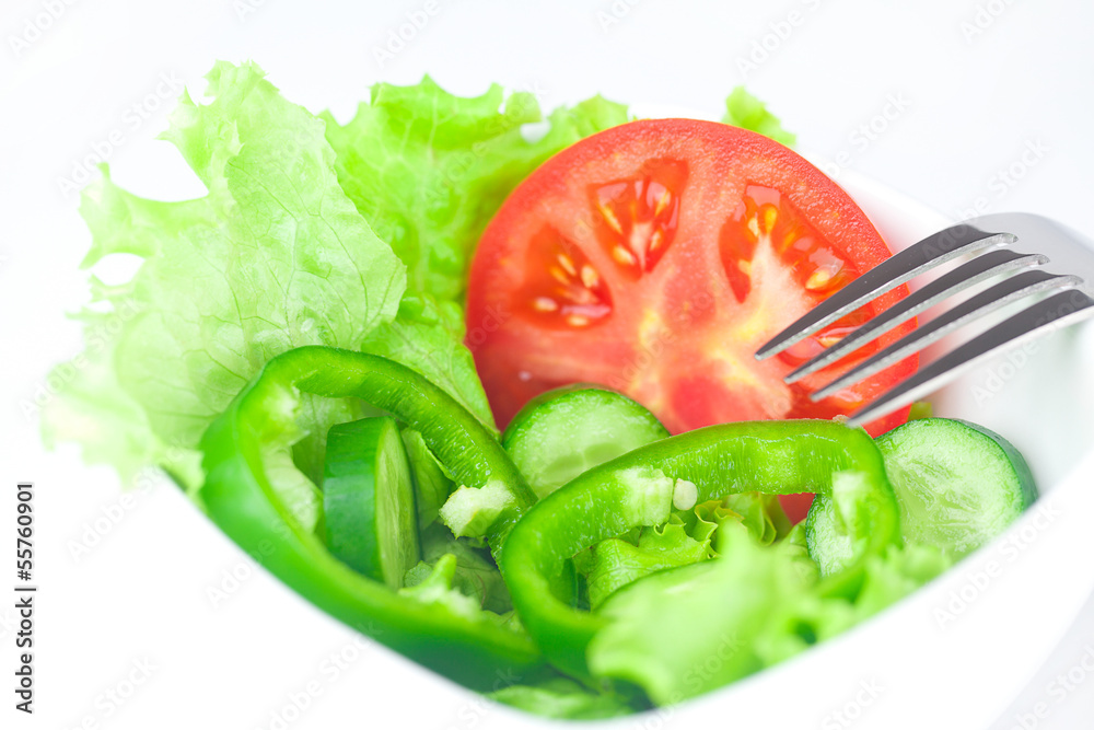 fork,lettuce, tomato, cucumber and pepper in a bowl isolated on fork,lettuce, tomato, cucumber and pepper in a bowl isolated on