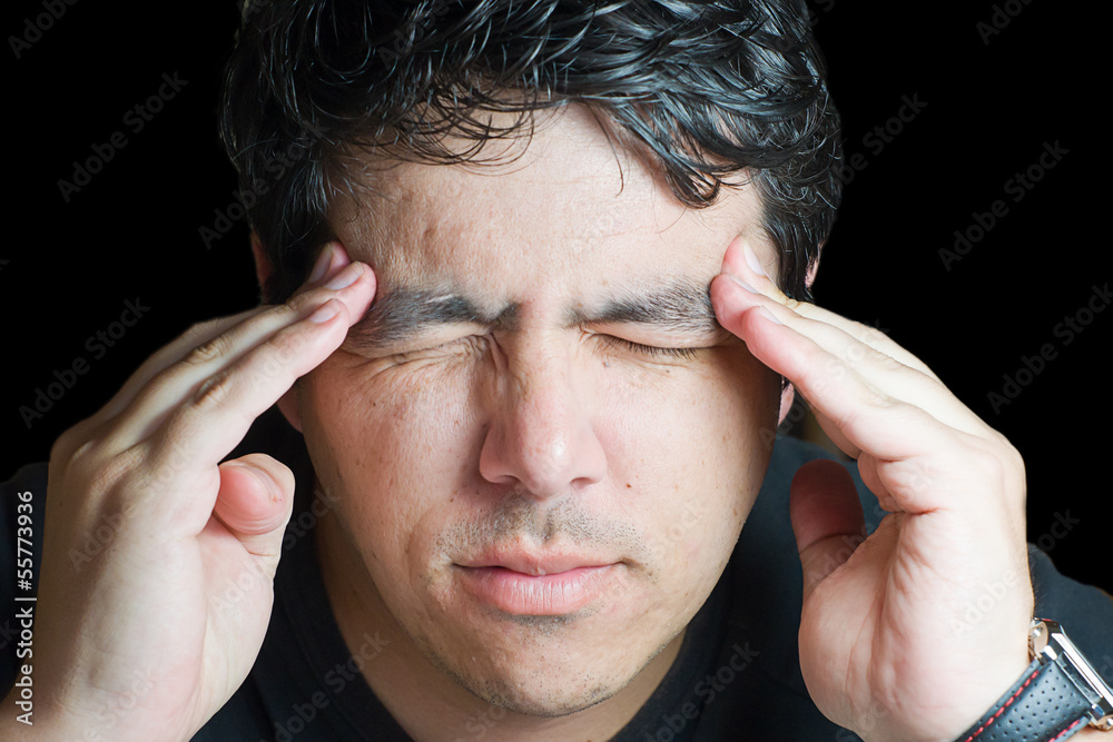 Fototapeta premium young man holding head in pain