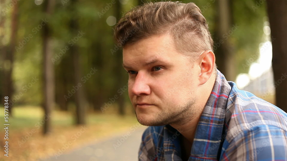 Depressed, sad young man sitting in the park, 1080p Depressed, sad young man sitting in the park, 1080p