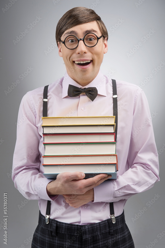Nerd with book stack. Young nerd man holding a book stack while Nerd with book stack. Young nerd man holding a book stack while