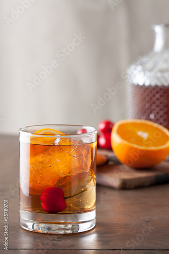 Classic old-fashioned cocktail on a wooden table