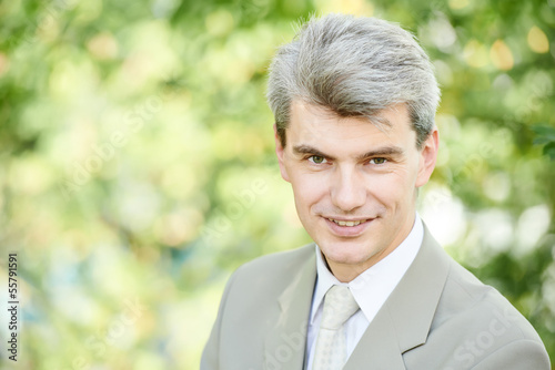 Smiling young businessman outdoors