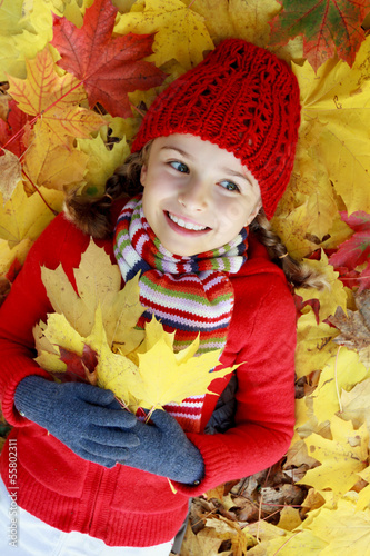 Autumn fun - girl playing in autumn leaves © Gorilla