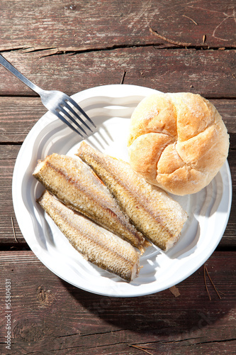 Fried fish on a plastic plate