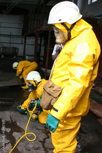 firefighters in chemical protection suit