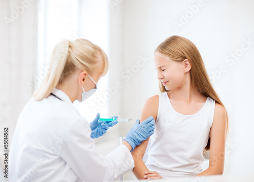 doctor doing vaccine to child in hospital