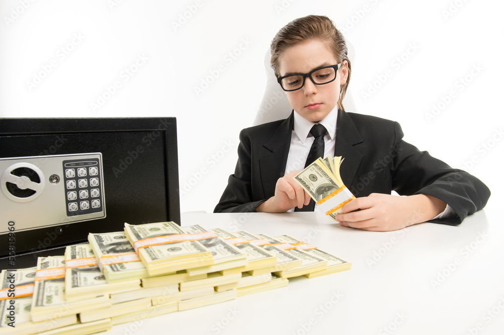 Counting money. Bossy little boy in formalwear counting money wh Counting money. Bossy little boy in formalwear counting money wh