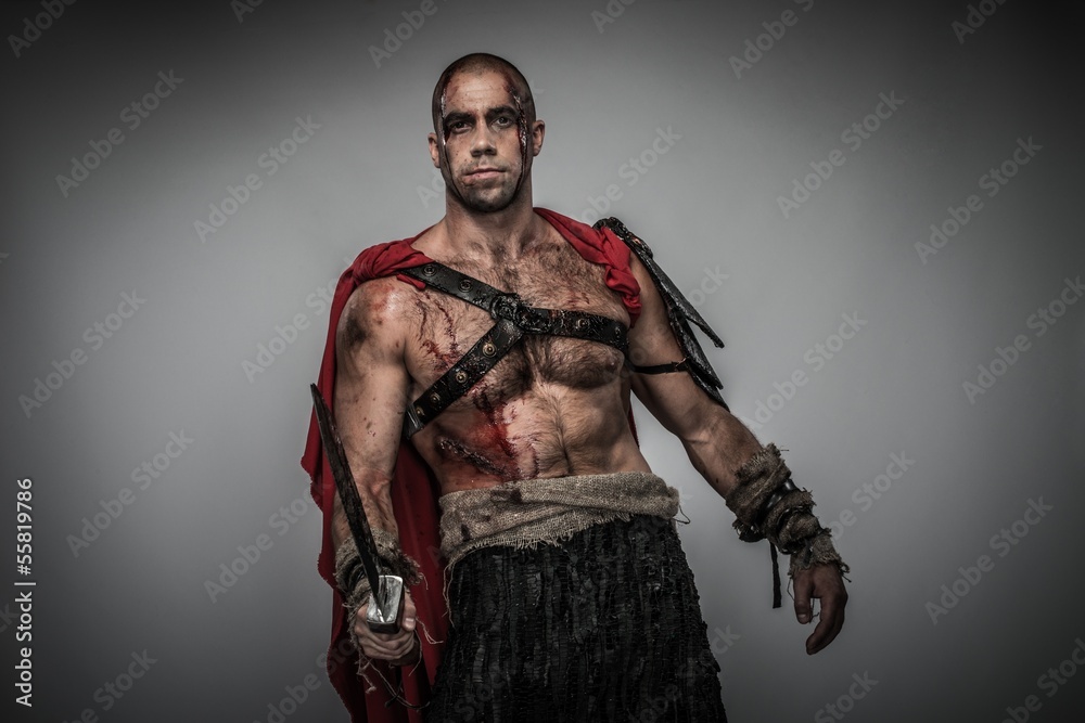 Wounded gladiator with sword covered in blood