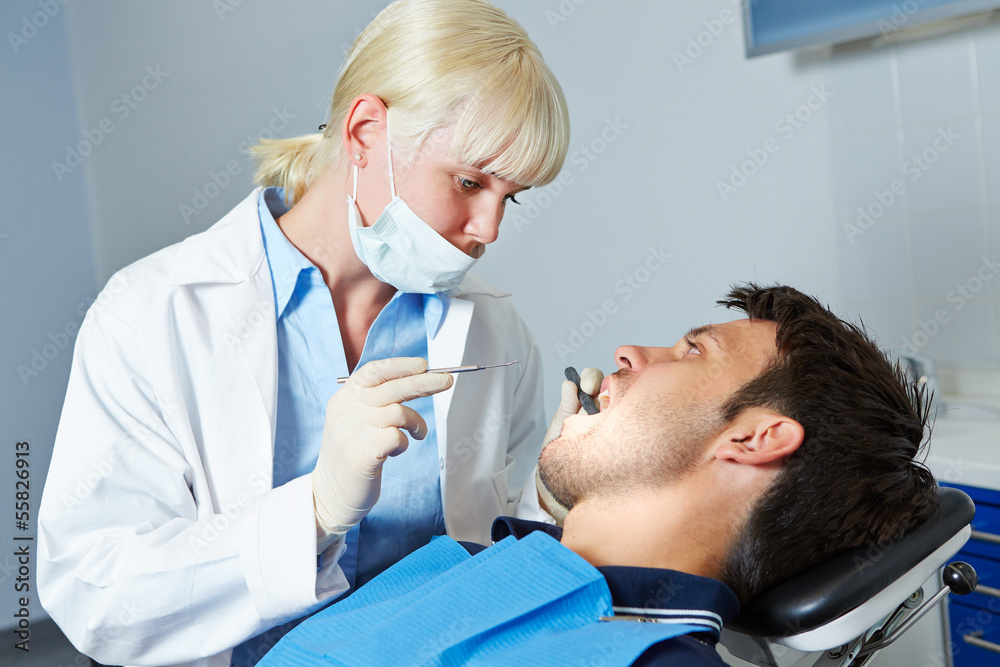 Fototapeta premium Dentist examining patient with toothache