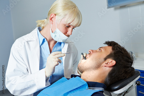 Dentist examining patient with toothache