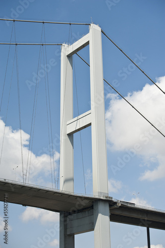 Fototapeta Naklejka Na Ścianę i Meble -  Suspension bridge support against blue sky