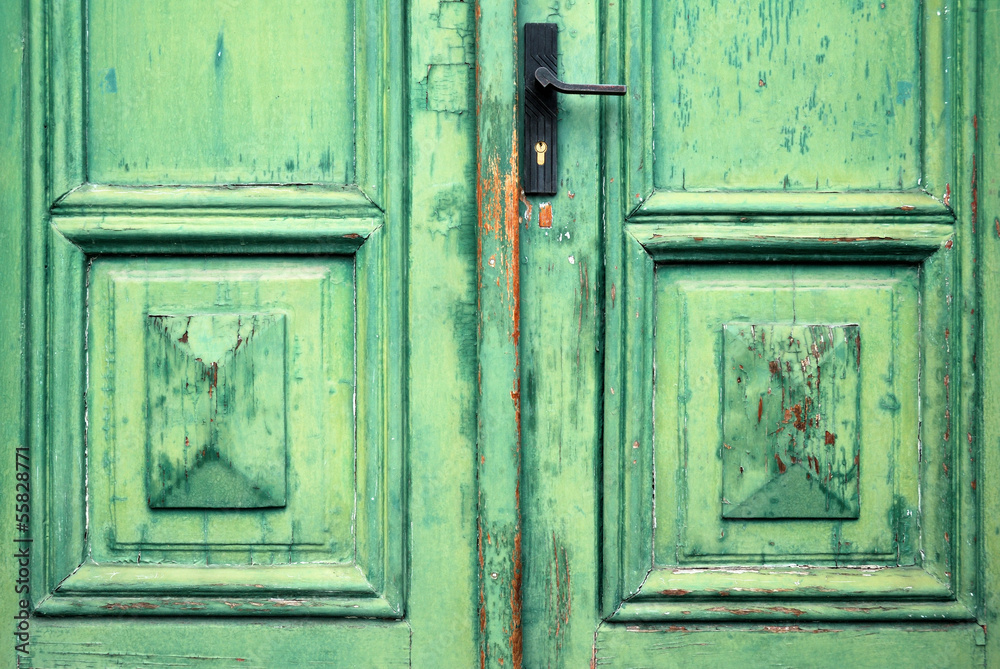 Old flaked classic green door and door handle