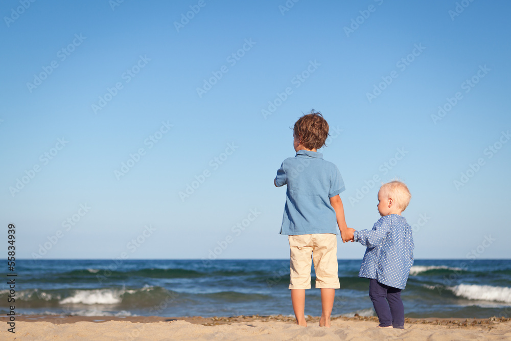 Brother and sister on walk near sea