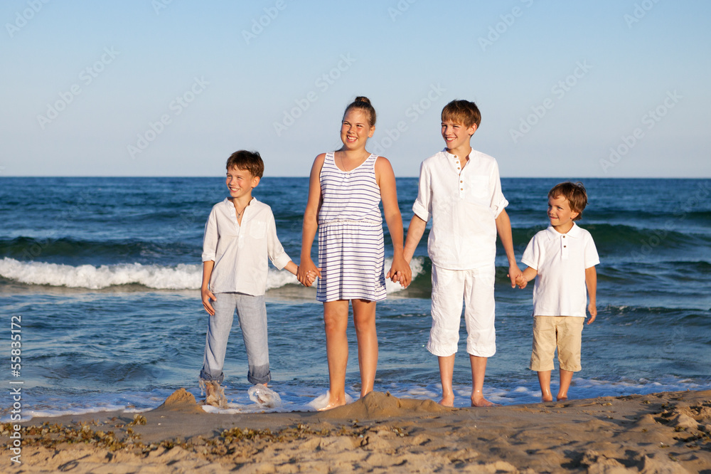 Children are standing on beach Children are standing on beach