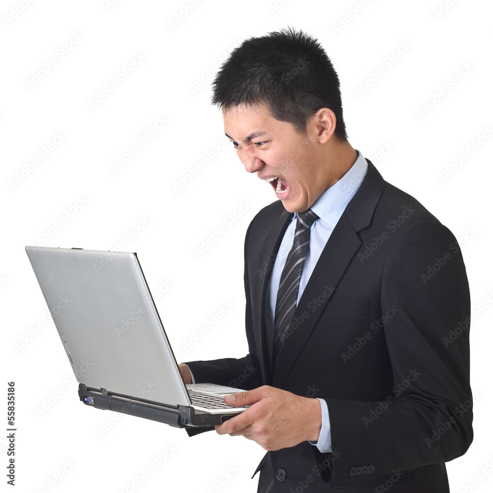 Angry business man holding laptop Angry business man holding laptop