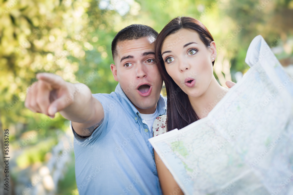 Mixed Race Couple Looking Over Map Outside Together Mixed Race Couple Looking Over Map Outside Together