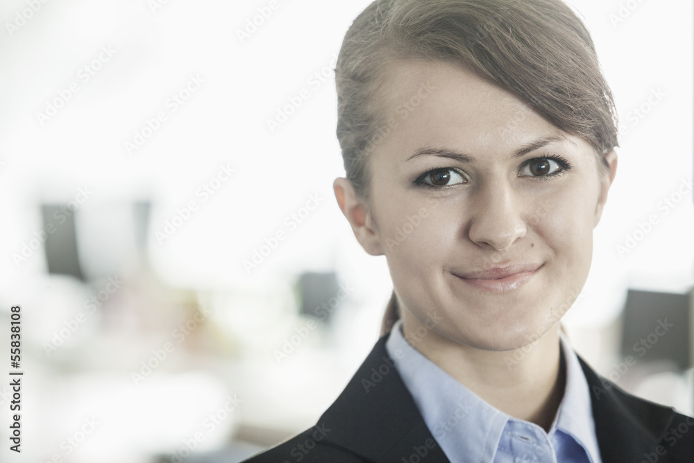 Portrait of smiling young businesswoman with bangs looking at the camera, head and shoulders Portrait of smiling young businesswoman with bangs looking at the camera, head and shoulders