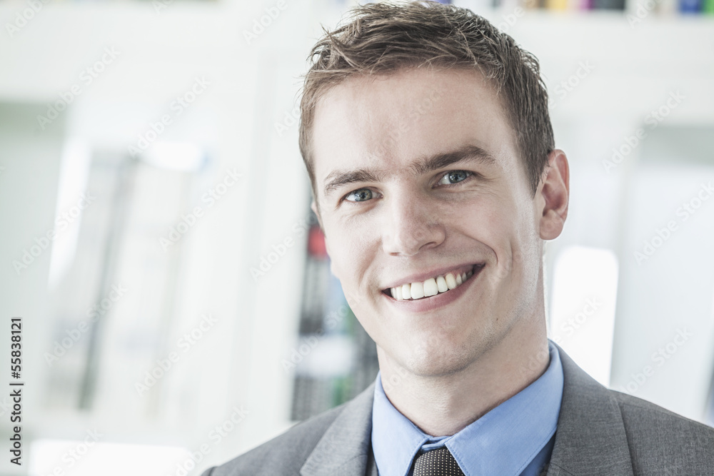 Portrait of young smiling businessman looking at camera, head and shoulders Portrait of young smiling businessman looking at camera, head and shoulders