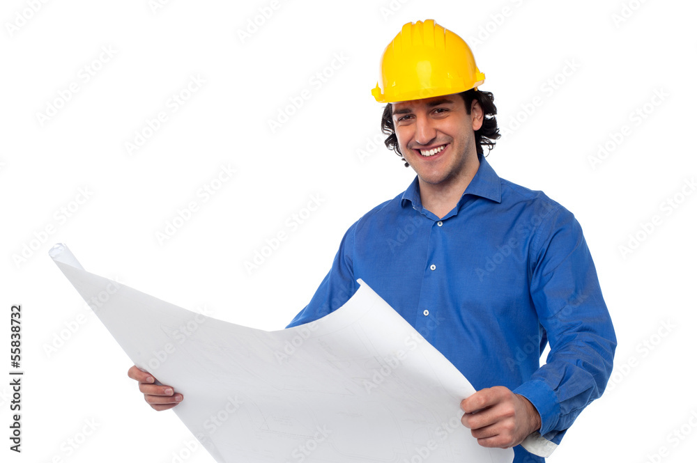 Construction worker reviewing blueprint Construction worker reviewing blueprint