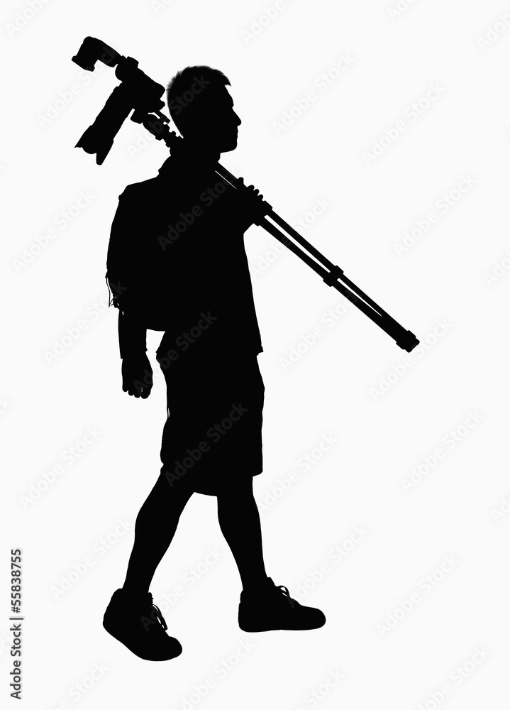 Silhouette of man carrying camera and tripod. Silhouette of man carrying camera and tripod.