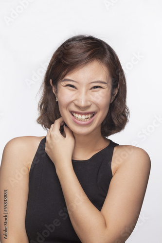 Smiling and happy young woman, portrait, studio shot