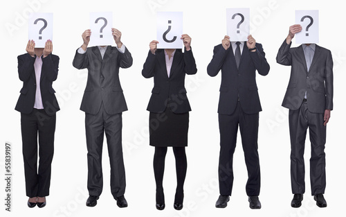 Five business people holding up paper with question mark, obscured face, studio shot