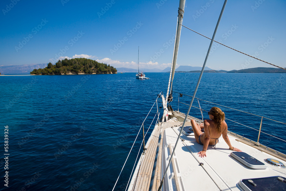 Young woman Sailing on a sailing yacht in Greece