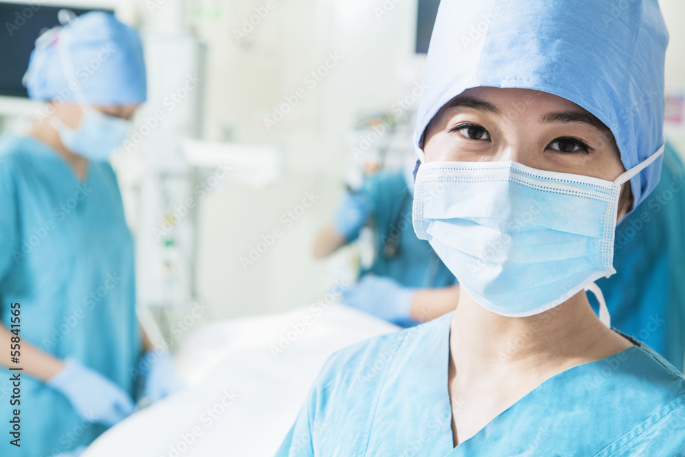Portrait of female surgeon wearing surgical mask in the operating room, close-up Portrait of female surgeon wearing surgical mask in the operating room, close-up