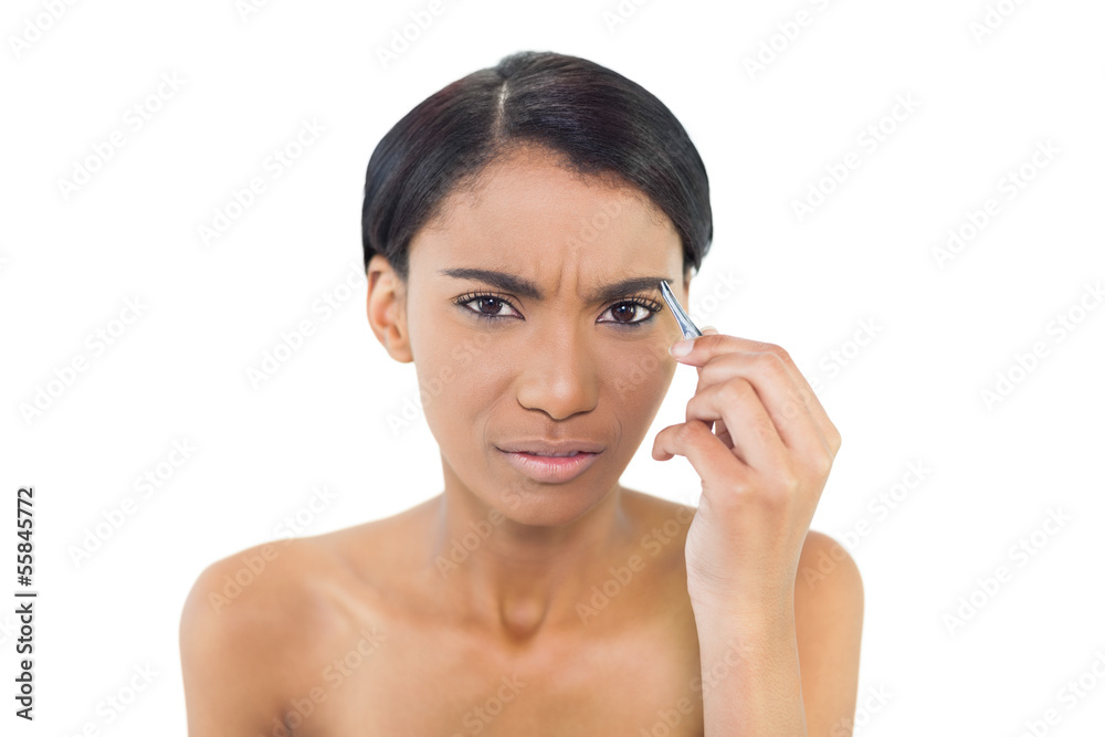Gorgeous natural model using tweezers on her eyebrow Gorgeous natural model using tweezers on her eyebrow