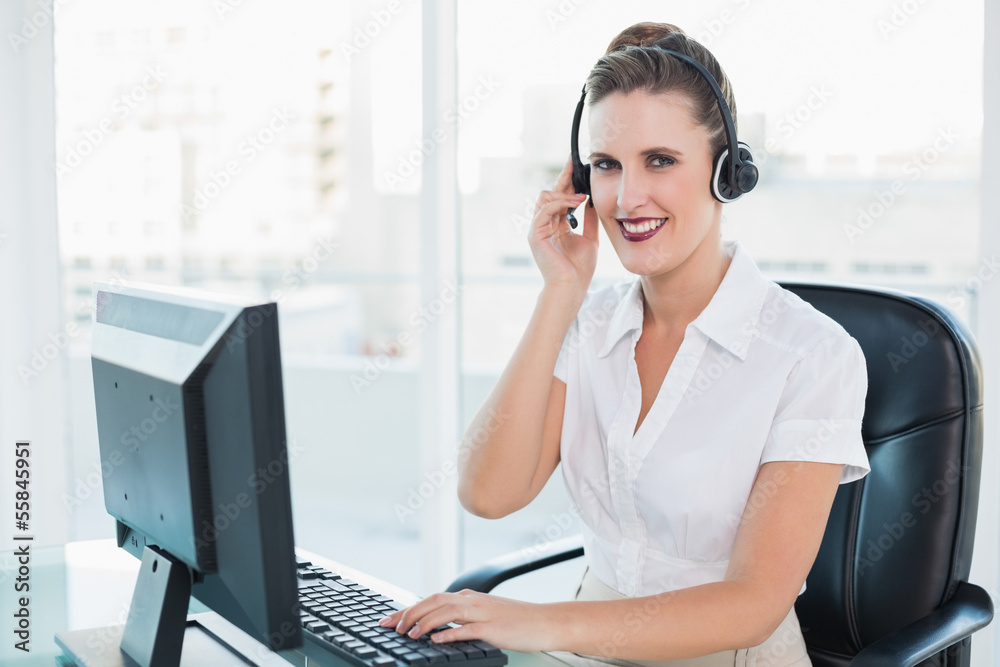 Happy call centre agent sitting on swivel chair Happy call centre agent sitting on swivel chair