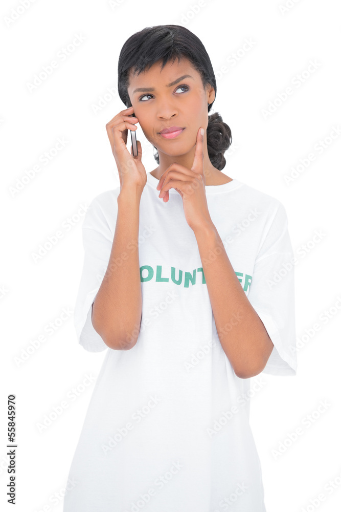 Wondering black haired volunteer calling someone with her mobile Wondering black haired volunteer calling someone with her mobile