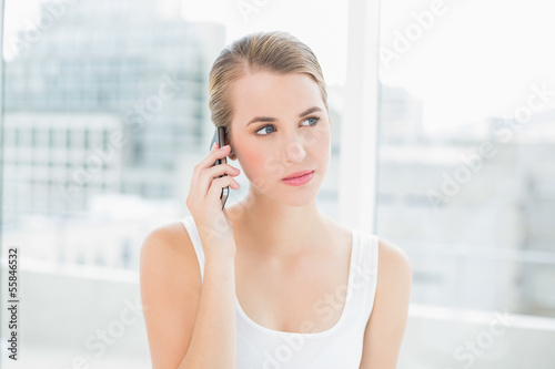 Free Download Thoughtful blond woman on the phone - GFXLoad