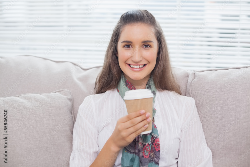 Smiling pretty model holding mug of coffee Smiling pretty model holding mug of coffee