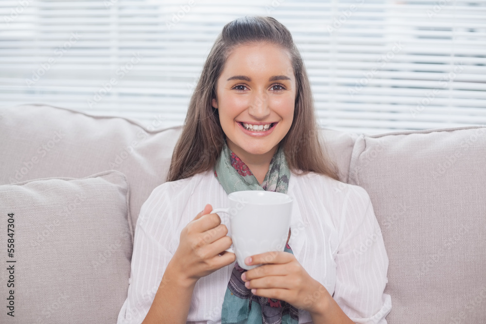 Cheerful pretty model holding cup of coffee Cheerful pretty model holding cup of coffee