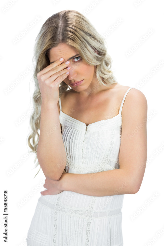Blond model having headache touching her forehead