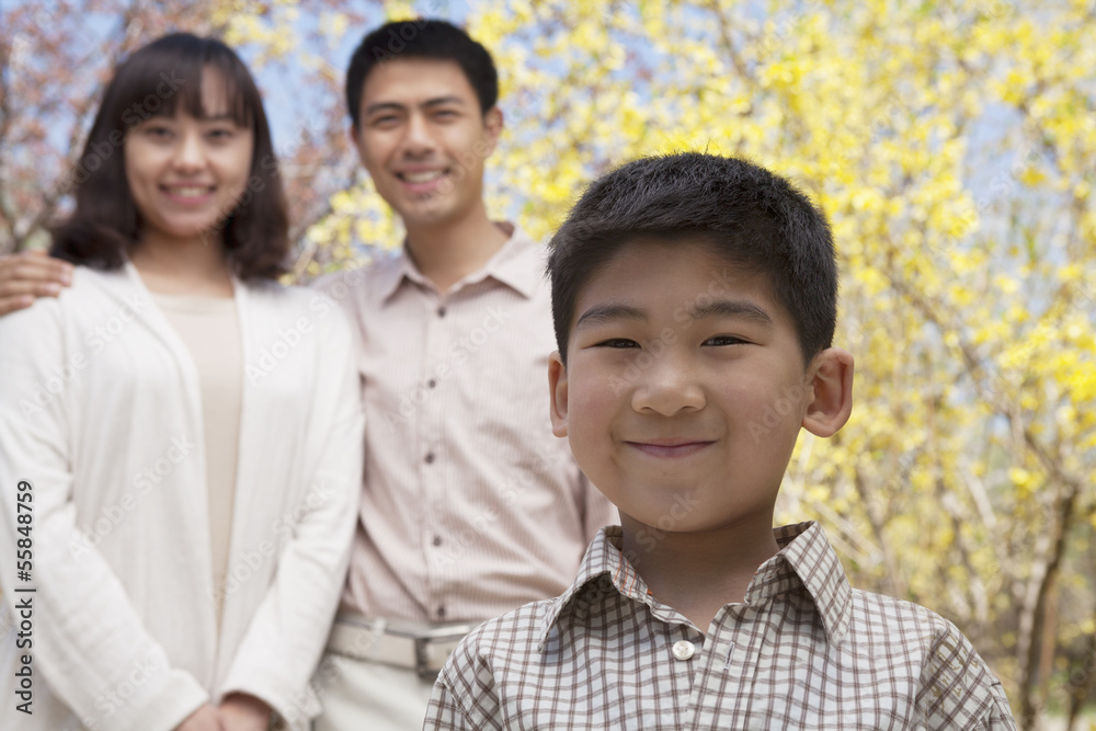 Portrait of happy smiling family in the park in springtime, Beijing, China Portrait of happy smiling family in the park in springtime, Beijing, China