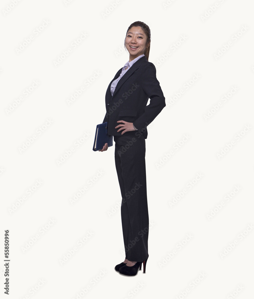 Portrait of smiling young businesswoman holding her personal organizer, full length, studio shot Portrait of smiling young businesswoman holding her personal organizer, full length, studio shot