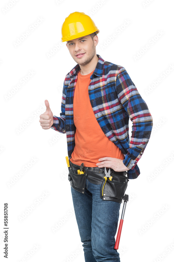 Handyman. Confident young handymen in hardhat holding thumb up w Handyman. Confident young handymen in hardhat holding thumb up w