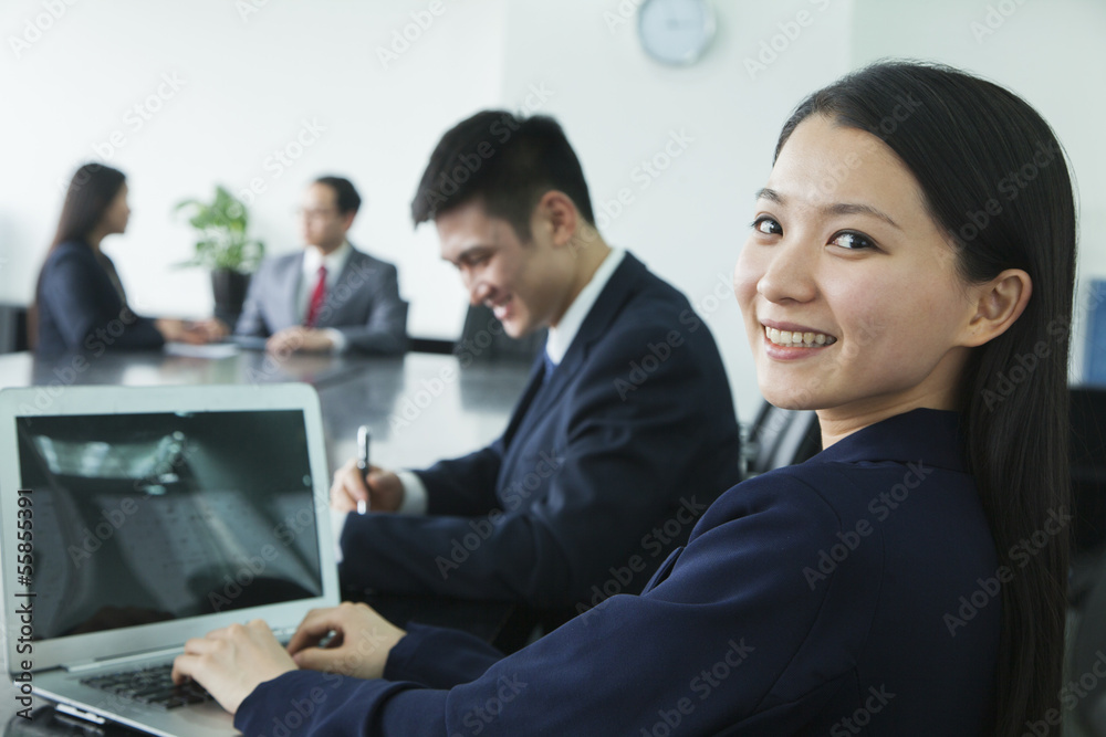 Businesswoman Looking Over Her Shoulder at the Camera Businesswoman Looking Over Her Shoulder at the Camera