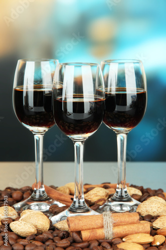 Glasses of liquors with almonds and coffee grains,