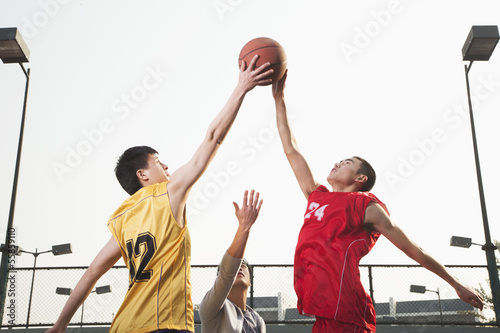 Basketball players fighting for a ball 