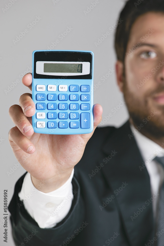 Portrait of a young businessman showing a zero on calculator. Portrait of a young businessman showing a zero on calculator.